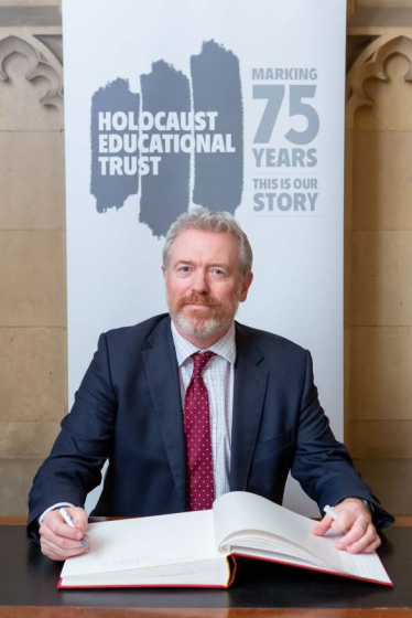 James signing theHolocaust Educational Trust Book of Commitment